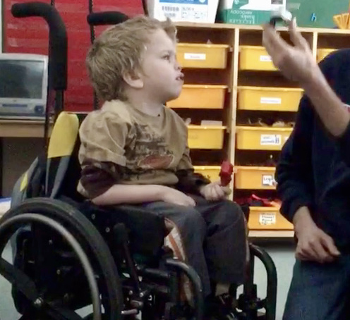 A student in a wheelchair is concentrating on his EA