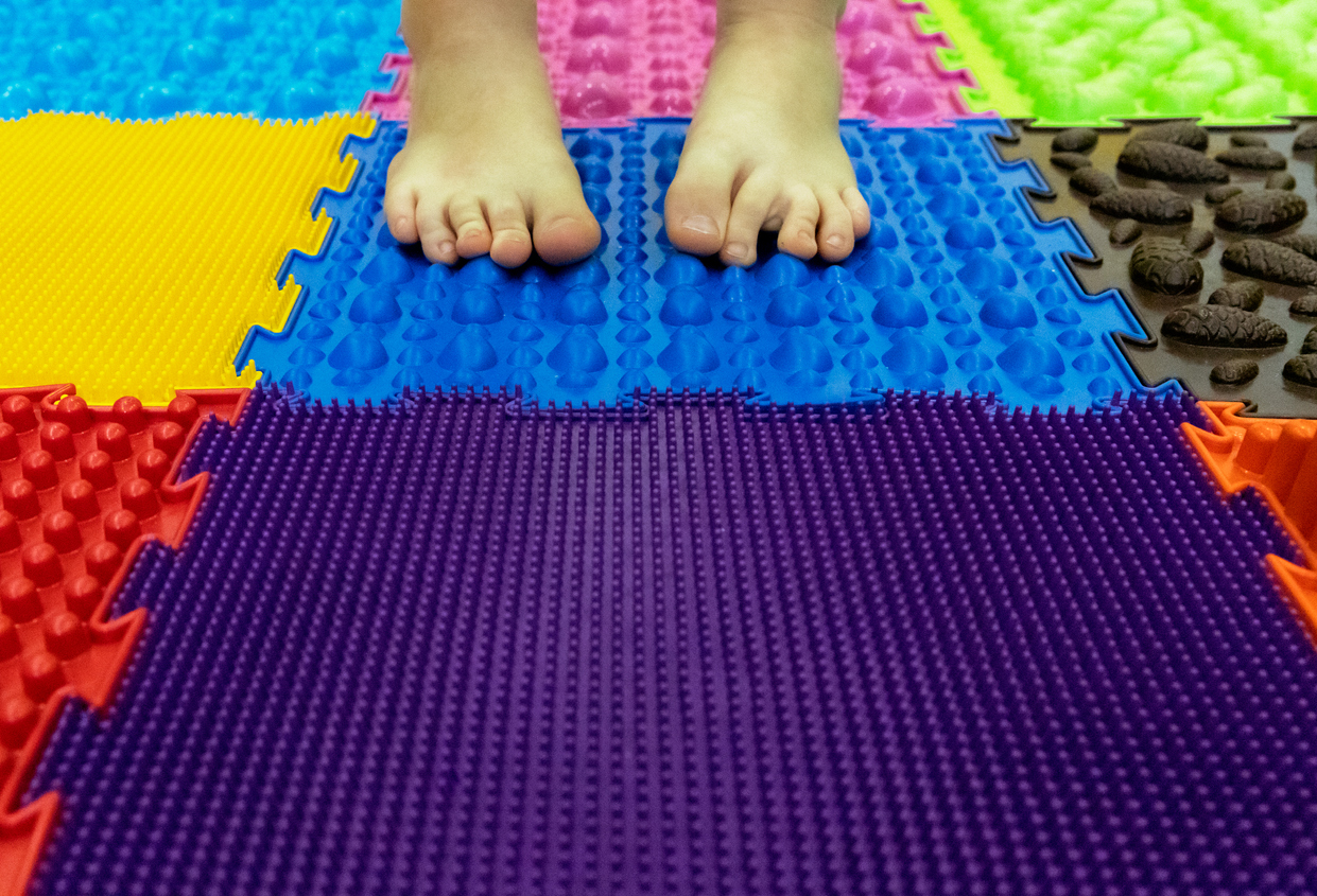 Children's feet on a sensory mat