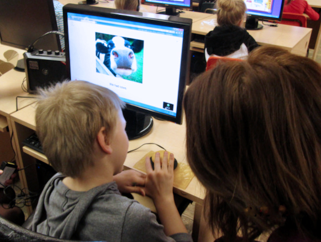 Student using a switch to access an e-book on a computer